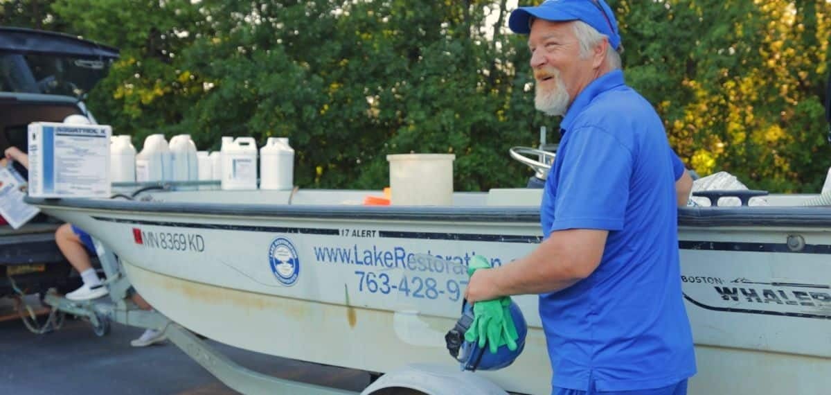 Steve in front of a Lake Restoration boat.